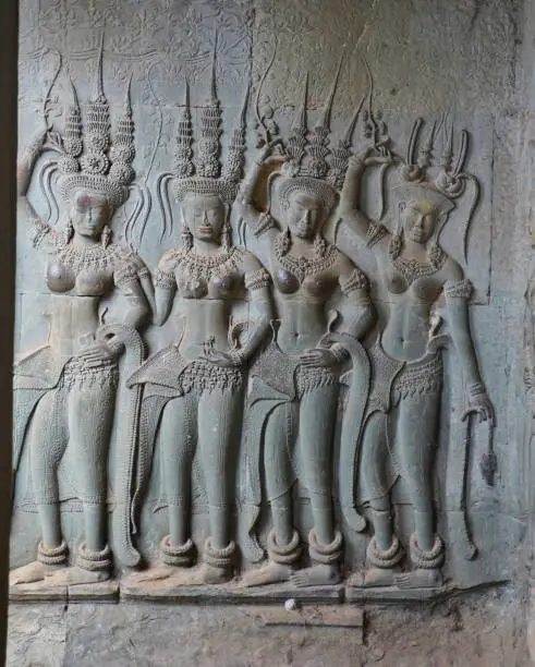 Apsara - Stone bas relief depicting Heavenly nymphs and celestial dancers at the courts of the Gods, carved in stone at Angkor Wat at Siem Reap, Cambodia, Asia