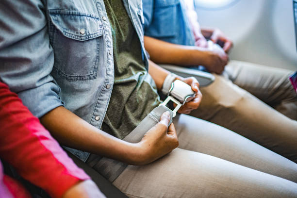 istock Passengers fastening seat belts while sitting on the airplane 1793311051