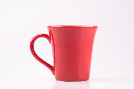 a red ceramic mug isolated on a white background from the front