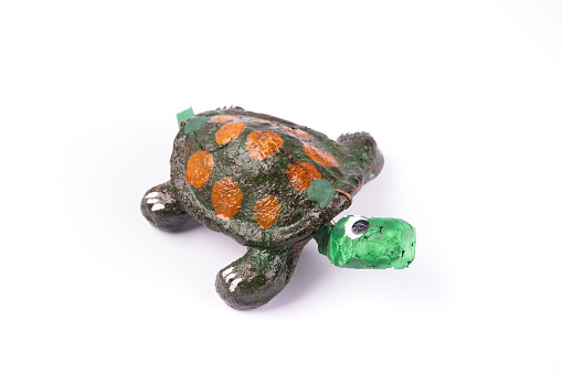 small craft and toy turtle isolated on white background