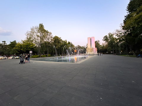 Mexico City, Mexico, November 5th, 2023. La Bombilla public park in the south of Mexico City on a weekend, with families and visitors around an illuminated fountain at sunset