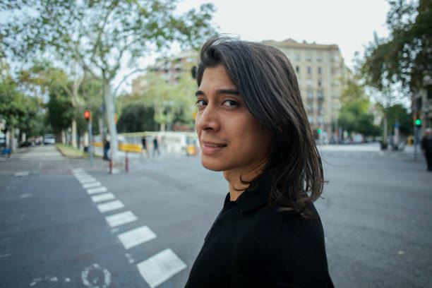 istock Young Latino man walking in the city 1793330425