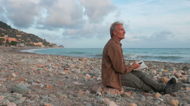 Mature man relaxes on empty beach