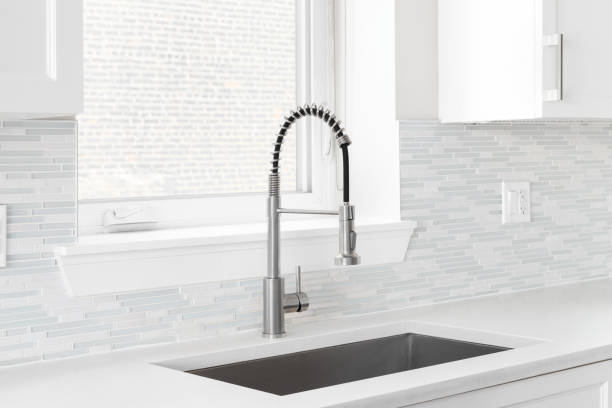 istock A kitchen faucet detail with a mosaic tile backsplash. 1793350963