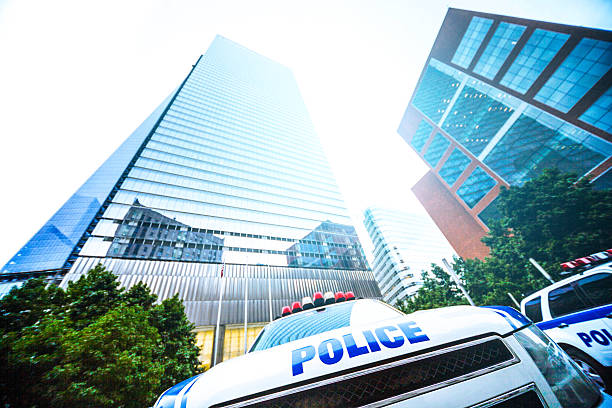 Police car parked under financial skyscraper