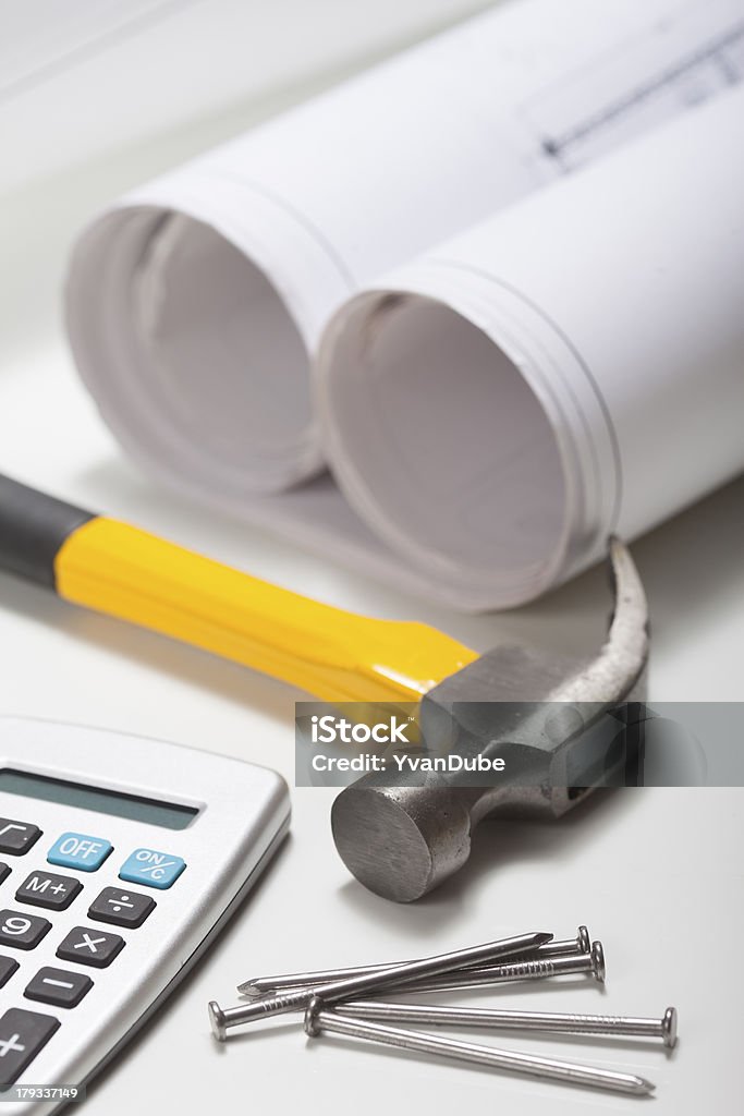 tools and rolled plan hammer nails calculator and rolled plans Blueprint Stock Photo