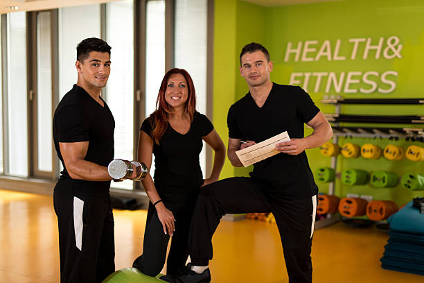 personal trainer at gym stock photo