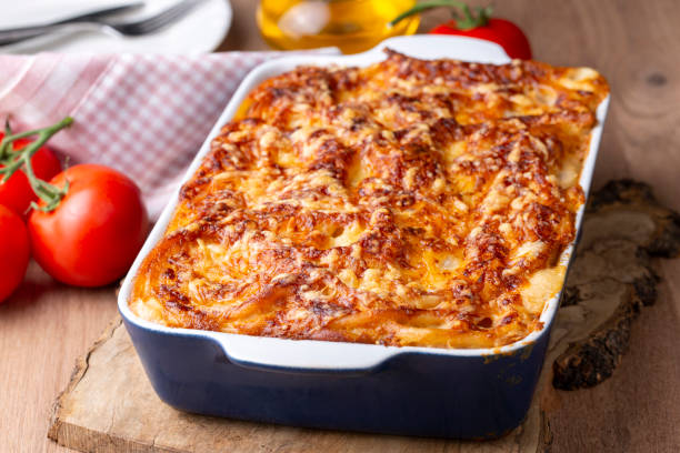 istock Pasta casserole bechamel sauce topped with melted mozzarella cheese and served in a white baking dish on a table (Turkish name; firinda makarna or firin makarna) 1793382696