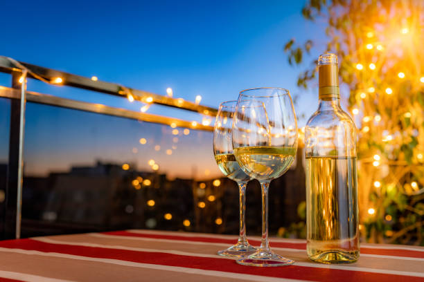 istock White wine bottle and two wineglasses on table at night 1793384881