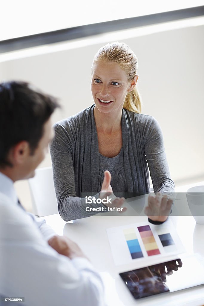 Explaining her design vision Two businesspeople having a discussion about a project together 30-34 Years Stock Photo