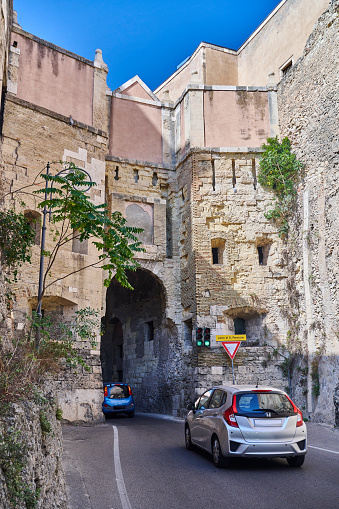 Cagliari, Italy - September 29, 2023: cars driving trough the St. Pancrazio Gate.