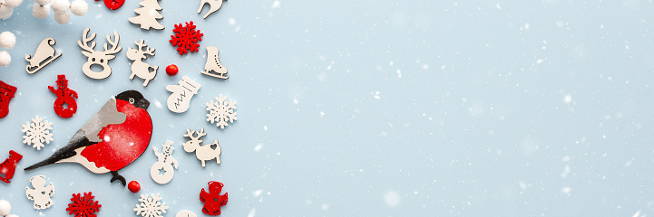 White and red Christmas toys on a blue background, Merry Christmas and Happy New Year banner, top view, copy space