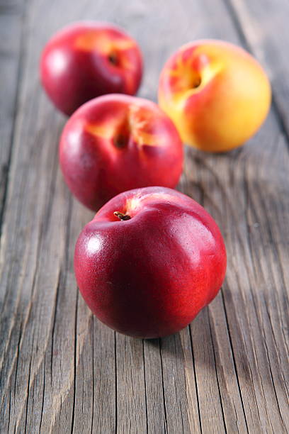 nectarines on wooden background stock photo