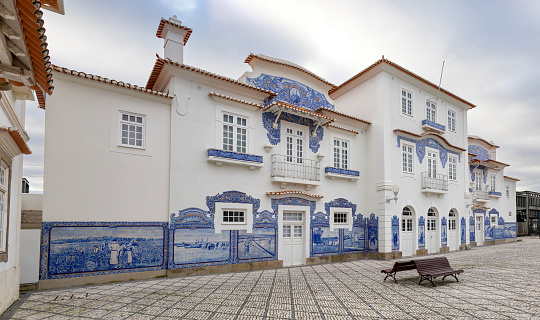 Railway station of Aveiro. The Aveiro Train Station is located in the city of Aveiro at the beginning of Avenida Lourenço Peixoto.  It was inaugurated on April 10, 1864 and the tiles date from its foundation to 1916. They were made in the extinct tile factory Fonte Nova de Aveiro.