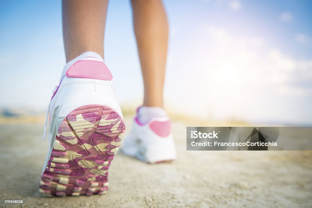 jogging shoes closeup Close up shoot of a woman's running shoes in the nature. Active Lifestyle Stock Photo