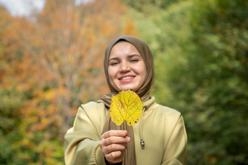 Autumn leaves and a beautiful woman in a headscarf