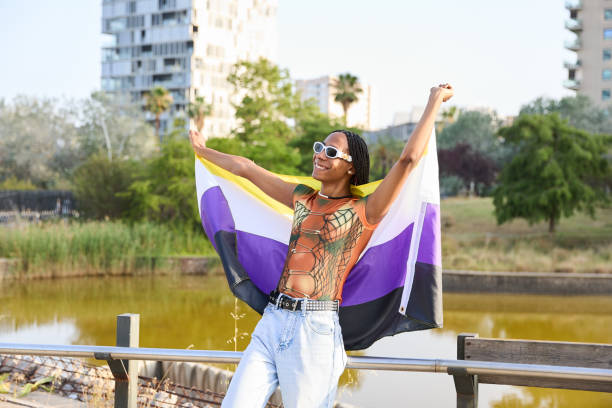 istock Cheerful African American non-binary person holding a flag 1793486640