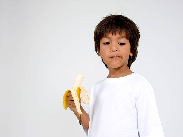 istock Hispanic boy eating a banana 179348839