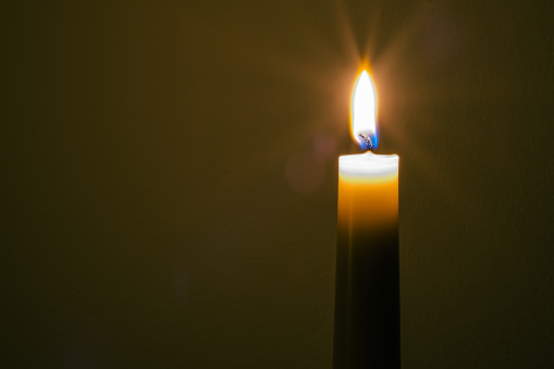 Background of burning candles in  a church.