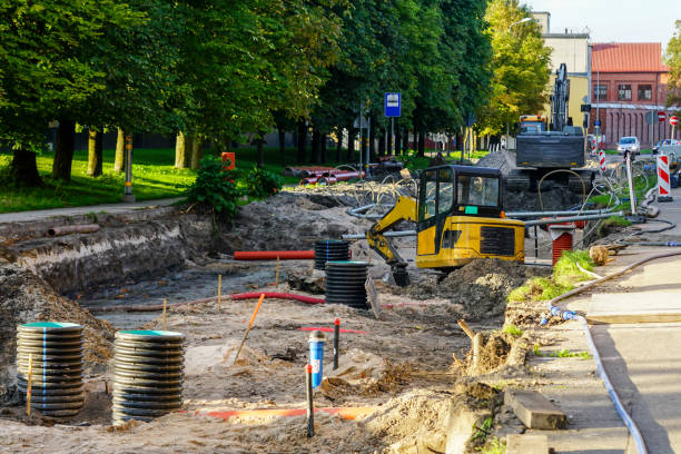 istock Street reconstruction view, replaced underground pipes, vertical plastic wells, excavators 1793489316