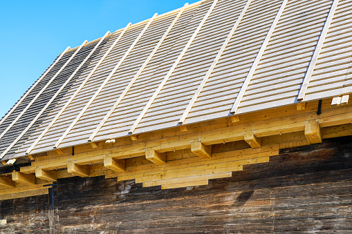 Restoration of the facade of an old wooden building, replacing the decayed wooden details, restoration of the roof covering