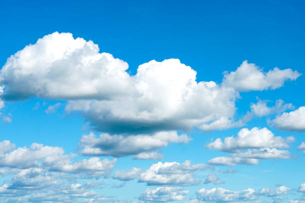 istock Clear blue sky with many white fluffy cumulus clouds with space for text background 1793490906