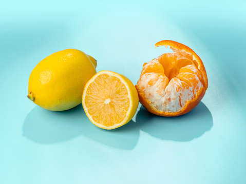Lemon fruit with leaf isolated. Whole lemon and a half with leaves on white background. Lemons isolated. With clipping path. Full depth of field