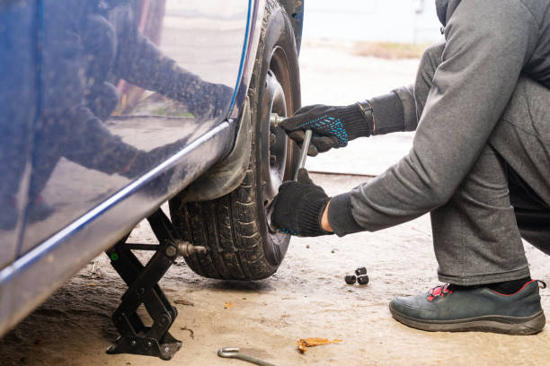 istock A man unscrews a car wheel in a garage. Replacing car wheels 1793511151