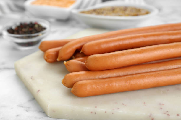 istock Fresh delicious sausages on white marble table 1793519088