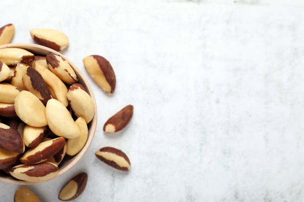 istock Delicious Brazil nuts on white table, flat lay. Space for text 1793520133