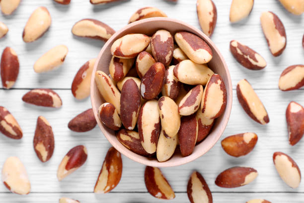 istock Delicious Brazil nuts on white wooden table, flat lay 1793521177