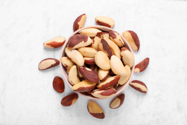 istock Delicious Brazil nuts on white table, flat lay 1793521192