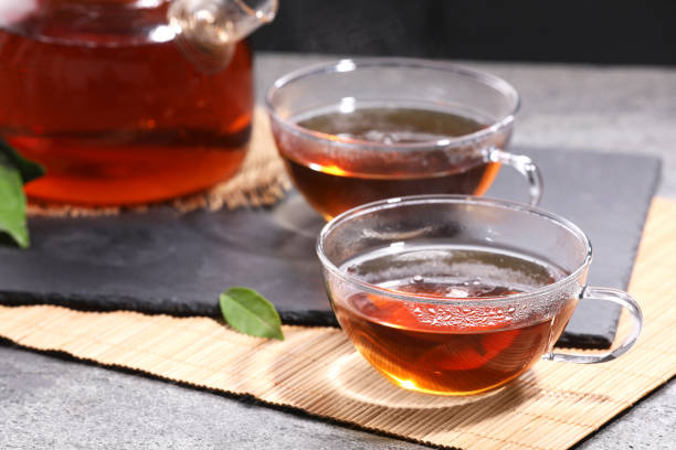istock Aromatic hot tea in glass cups and teapot on light grey table, closeup 1793528250
