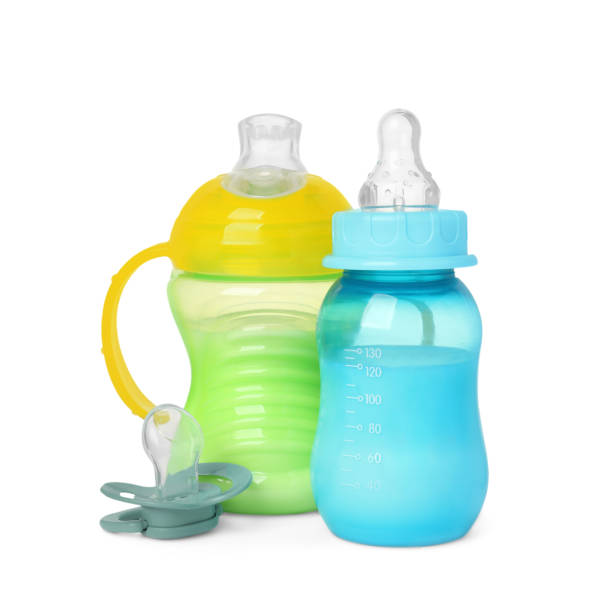 istock Feeding bottles with milk and pacifier on white background 1793531469