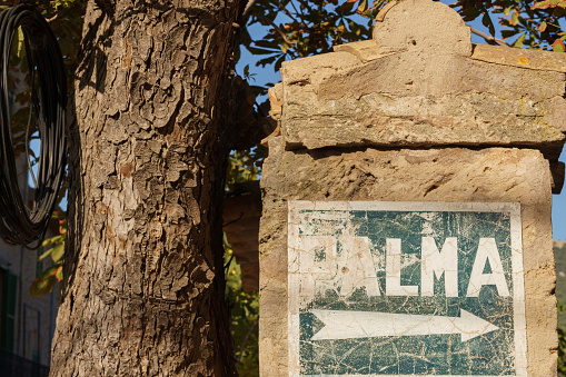 Valldemossa, Spain-August 2022:  Ancient road sign to Palma de Mallorca sited in Valldemossa, Mallorca island