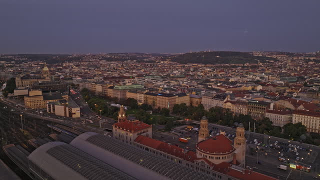 Prague Czechia Aerial v75 low flyover Zizkov across Vinohrady capturing cityscape of New and Old Town and busy vehicle traffics on Wilsonova at dawn sunrise - Shot with Mavic 3 Cine - November 2022