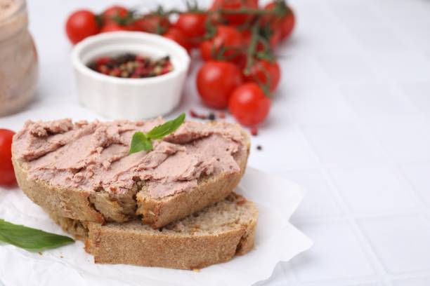 istock Delicious liverwurst sandwich with basil on white table, closeup. Space for text 1793561391