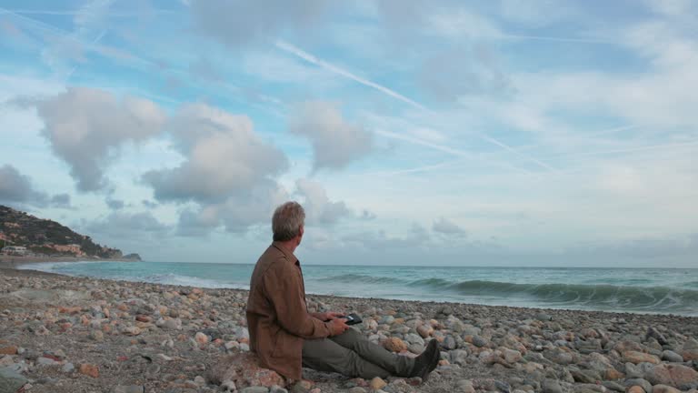 Mature man relaxes on empty beach