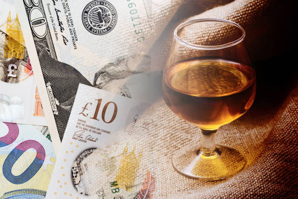 alcohol price background. whisky excise. increasing high alcohol tax. british pound, euro and dollar currency. - costless imagens e fotografias de stock