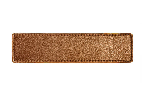 istock Brown leather belt strap closeup isolated on white. Brown titched leather seam frame label tag isolated on white. Empty copy space fashion background. 1793603186