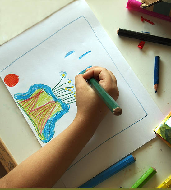 istock 5-year-old child's hand drawing flowers 179360706