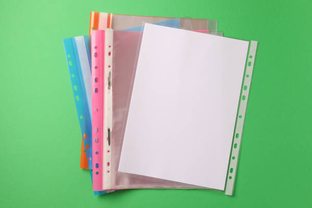 istock File folders with punched pockets on green background, flat lay 1793611173
