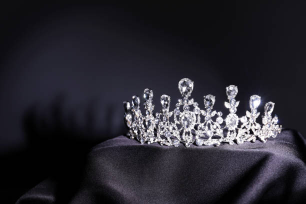 istock Beautiful silver tiara with diamonds on black cloth. Space for text 1793617961