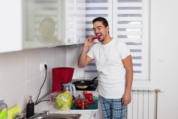 istock Young man enjoys fresh pepper snack 1793626548