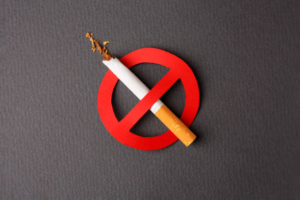 istock Cigarette with prohibition sign on dark grey background, top view. Quitting smoking concept 1793628703