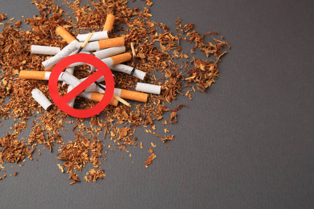 istock Prohibition sign, broken cigarettes and burnt matches on dark grey background, space for text. Quitting smoking concept 1793629244