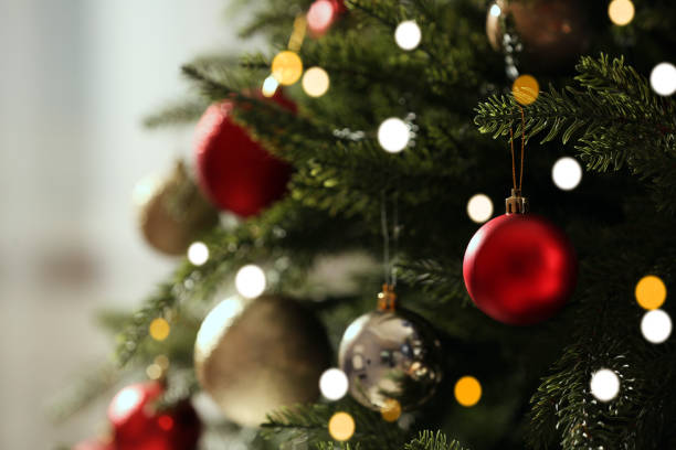 istock Christmas tree with beautiful baubles on blurred background, closeup. Space for text 1793638952