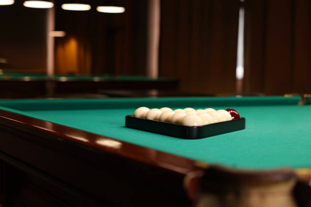 istock Billiard balls in triangle rack on green table indoors, space for text 1793638961