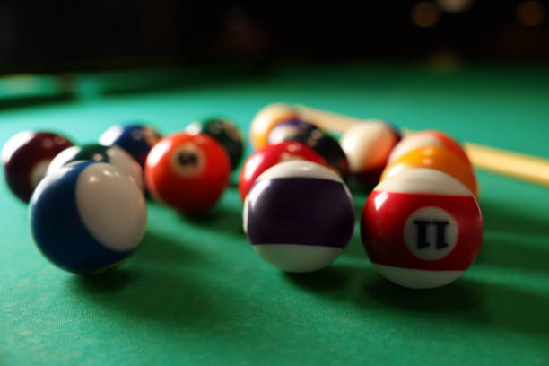 istock Many colorful billiard balls on green table, closeup 1793640624