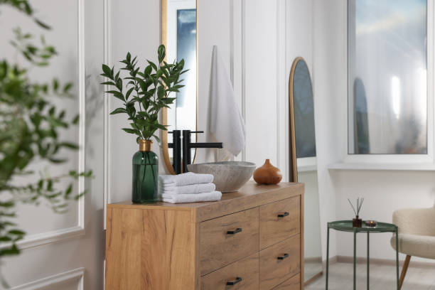 istock Modern bathroom interior with stylish mirror, eucalyptus branches, vessel sink and wooden vanity 1793641706